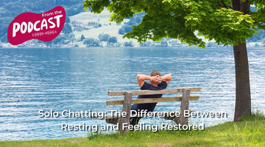 A man is sitting on a bench with his hands behind his head. He's looking out over a shimmering blue lake. The wording 'Solo Chatting: The Difference Between Resting and Feeling Restored', the blog article title, is at the bottom of the image.